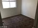 A bright bedroom features neutral walls, standard window, and wall-to-wall carpeting at 11882 Snow Bank St, Las Vegas, NV 89183