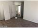 Bedroom featuring neutral walls, wall-to-wall carpet, base trim and open closet at 11882 Snow Bank St, Las Vegas, NV 89183