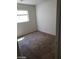 Small carpeted bedroom with neutral paint and a window for light at 11882 Snow Bank St, Las Vegas, NV 89183