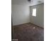 Carpeted bedroom featuring neutral colors and a window for natural light at 11882 Snow Bank St, Las Vegas, NV 89183