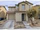 Inviting two-story home with a well-maintained lawn, desert landscaping, and an attached one car garage at 11882 Snow Bank St, Las Vegas, NV 89183