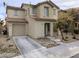 Inviting two-story home with a well-maintained lawn, desert landscaping, and an attached one car garage at 11882 Snow Bank St, Las Vegas, NV 89183