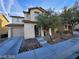 Inviting two-story home with a well-maintained lawn, desert landscaping, and an attached one car garage at 11882 Snow Bank St, Las Vegas, NV 89183