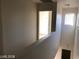 Bright hallway upstairs with an open doorway to a bedroom and small window at 11882 Snow Bank St, Las Vegas, NV 89183