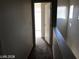 Bright hallway upstairs with an open doorway to a bedroom and small window at 11882 Snow Bank St, Las Vegas, NV 89183