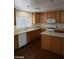 Well-lit kitchen features wood cabinets, laminate countertops, and stainless steel microwave at 11882 Snow Bank St, Las Vegas, NV 89183