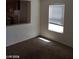 Bright living room featuring neutral paint, carpet floors, and a window with natural light at 11882 Snow Bank St, Las Vegas, NV 89183
