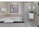 Bright bathroom featuring a luxurious soaking tub and separate glass-enclosed shower at 145 E Harmon Ave # 409, Las Vegas, NV 89109