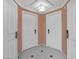 Hallway featuring tiled floors and multiple doors, with neutral-toned walls and modern lighting at 145 E Harmon Ave # 409, Las Vegas, NV 89109