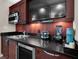 Wet bar with stainless steel appliances, dark wood cabinetry, and counter-height sink at 145 E Harmon Ave # 409, Las Vegas, NV 89109