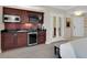 Modern kitchenette with microwave, sink, mini-fridge and adjacent king bed at 145 E Harmon Ave # 409, Las Vegas, NV 89109