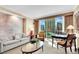 Bright living room features cityscape views, comfortable seating, and neutral decor at 145 E Harmon Ave # 409, Las Vegas, NV 89109