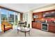 Living room and partial kitchen with seating area and expansive city views at 145 E Harmon Ave # 409, Las Vegas, NV 89109