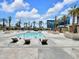 Outdoor pool area featuring palm trees, lounge chairs, and cabanas at 145 E Harmon Ave # 409, Las Vegas, NV 89109