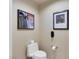 Neutral-toned toilet room featuring a modern toilet and framed artwork at 145 E Harmon Ave # 409, Las Vegas, NV 89109