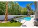 Backyard featuring a pool, spa, and lush landscaping for privacy at 153 Cascade Lake St, Las Vegas, NV 89148