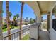 This covered balcony features palm trees and a view of the neighborhood street at 153 Cascade Lake St, Las Vegas, NV 89148