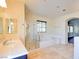 Bright bathroom with marble floors, glass shower, and separate tub at 153 Cascade Lake St, Las Vegas, NV 89148
