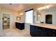 Bathroom featuring dual sinks, vanities, tile flooring, and large mirrors at 153 Cascade Lake St, Las Vegas, NV 89148