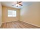 Neutral bedroom with wood-look flooring, base trim and a ceiling fan with lighting at 153 Cascade Lake St, Las Vegas, NV 89148