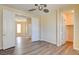 Bedroom featuring wood laminate floors, closet, and adjoining room with natural light at 153 Cascade Lake St, Las Vegas, NV 89148