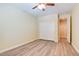 Bedroom with wood-look flooring, white base trim, a ceiling fan and a double door closet at 153 Cascade Lake St, Las Vegas, NV 89148