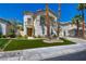 Charming two-story home featuring stucco siding, balcony, manicured lawn, and desert landscaping at 153 Cascade Lake St, Las Vegas, NV 89148