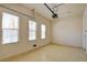 The well-lit garage features three windows, an automatic door opener, and neutral-colored walls at 153 Cascade Lake St, Las Vegas, NV 89148