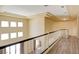 Second story hall area with black and white banister and multiple paned windows for natural light at 153 Cascade Lake St, Las Vegas, NV 89148