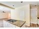 Granite countertop island with a gas cooktop sits between a door and living area at 153 Cascade Lake St, Las Vegas, NV 89148