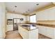 Open kitchen featuring an island with granite countertops and modern stainless steel appliances at 153 Cascade Lake St, Las Vegas, NV 89148