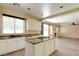 Kitchen overlooking living area featuring a granite island, white cabinets and stainless appliances at 153 Cascade Lake St, Las Vegas, NV 89148