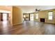Open-concept living room with laminate floors, fireplace, and access to the backyard at 153 Cascade Lake St, Las Vegas, NV 89148
