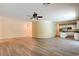 Expansive living room with adjacent kitchen featuring laminate floors, neutral walls, and recessed lighting at 153 Cascade Lake St, Las Vegas, NV 89148