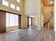 Bright, open living room with tall windows, wood laminate flooring, and staircase at 153 Cascade Lake St, Las Vegas, NV 89148