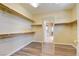 Walk-in closet offering ample shelf storage with modern wood-look floors at 153 Cascade Lake St, Las Vegas, NV 89148