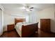 Well-lit bedroom with hardwood floors, a ceiling fan, and traditional wooden furniture at 2008 Spruce Brook Dr, Henderson, NV 89074