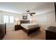 Comfortable carpeted main bedroom featuring a ceiling fan and natural light at 2008 Spruce Brook Dr, Henderson, NV 89074