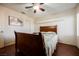 Well-lit bedroom with hardwood floors, a ceiling fan, and a large window with plantation shutters at 2008 Spruce Brook Dr, Henderson, NV 89074