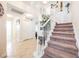 Bright, open entryway with staircase, tile floors, and views of multiple rooms at 2008 Spruce Brook Dr, Henderson, NV 89074