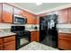 Kitchen features granite countertops, wood cabinets and stainless steel appliances at 2008 Spruce Brook Dr, Henderson, NV 89074