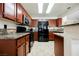 Kitchen features granite countertops, wood cabinets and stainless steel appliances at 2008 Spruce Brook Dr, Henderson, NV 89074