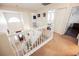 Bright entryway staircase with white railings and a view of the front door and an arched window at 2008 Spruce Brook Dr, Henderson, NV 89074
