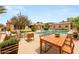 Spacious backyard with a large pool, outdoor seating, and a dining area, perfect for entertaining and enjoying the outdoors at 215 Great Gable Dr, Las Vegas, NV 89183