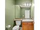 Small bathroom with green walls, a sink with a wooden cabinet, and tiled accents at 215 Great Gable Dr, Las Vegas, NV 89183