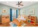 Bright bedroom with hard wood flooring, ceiling fan and two decorative windows at 215 Great Gable Dr, Las Vegas, NV 89183