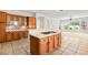 Bright kitchen with wooden cabinets, tile countertops and backsplash, and views to a living area at 215 Great Gable Dr, Las Vegas, NV 89183