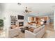 Open concept living room with fireplace, kitchen views, and comfortable seating at 215 Great Gable Dr, Las Vegas, NV 89183