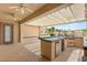 Covered patio features a built-in outdoor kitchen with grill, refrigerator and bar area, perfect for entertaining guests at 215 Great Gable Dr, Las Vegas, NV 89183