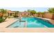 Private backyard oasis with a large pool, lush palm trees, and a detached structure creating a serene retreat at 215 Great Gable Dr, Las Vegas, NV 89183